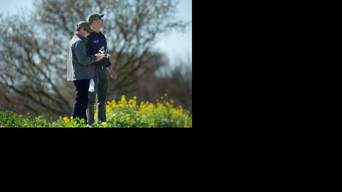 
Nature Conservancy Conservation analyst Chris McColl pilots a remote-controlled helicopter as Nature Conservancy project director Judah Grossman watches the unmanned aircraft along the Cosumnes River in Sacramento. The site flooded in early February, the first large-scale flood on the project site since strategic levee removal was completed last summer. 
