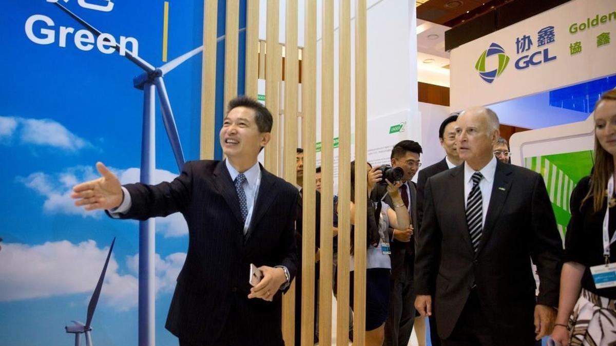 Gov. Jerry Brown, right, is shown an exhibition at an international clean energy conference in Beijing, where he signed an agreement to work together to fight climate change. State officials announced that carbon emissions in California fell 0.3 percent in 2015 and have declined 10 percent since 2004.