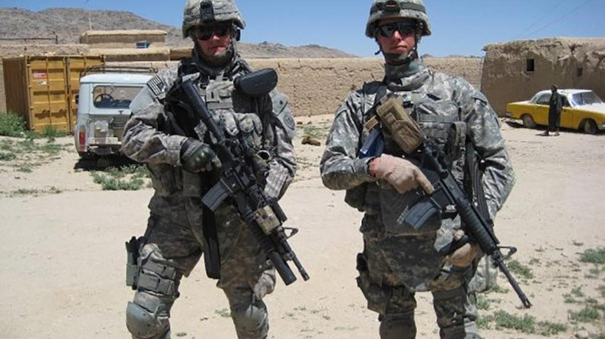 Matt Zeller, left, said he was outgunned in a firefight and didn’t notice two insurgents coming from behind – until they were shot by Janis Shinwari, right, his Afghan translator. Zeller has co-founded a nonprofit to help relocate former translators.