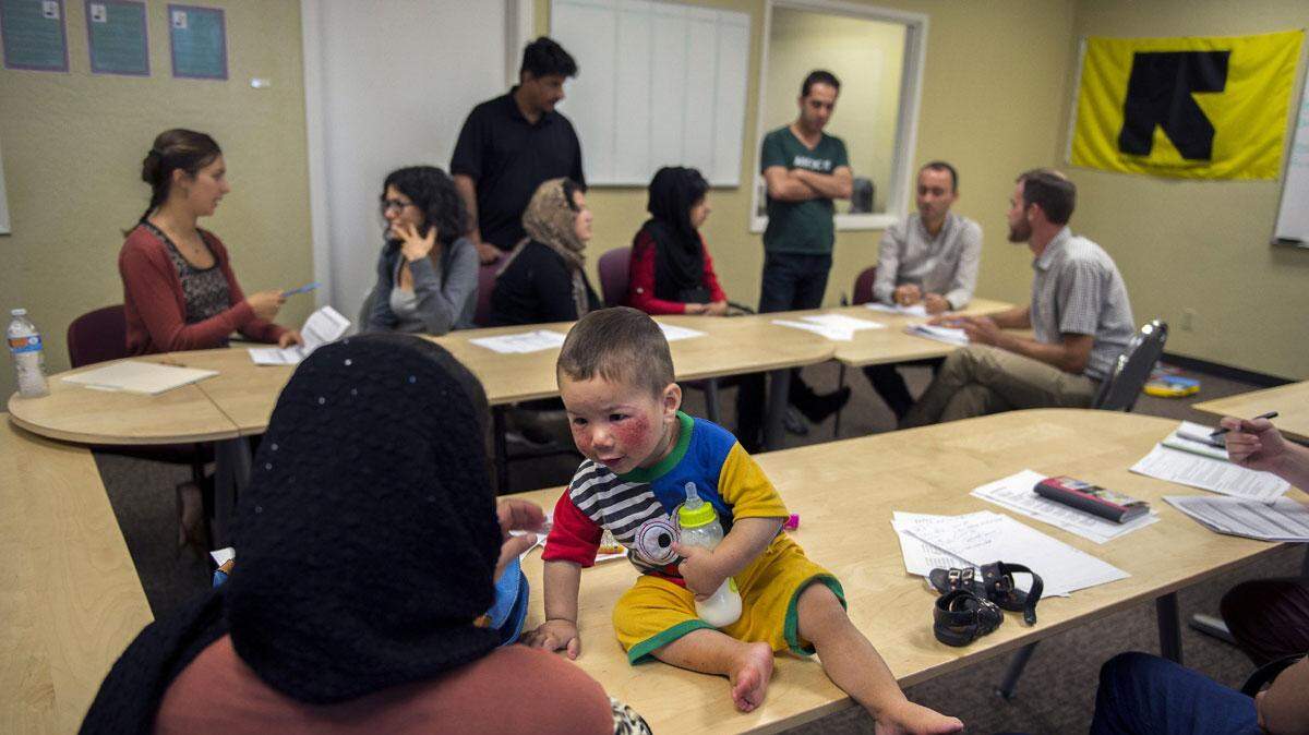 Ahmad Farzad Ghafoori, almost 2, attends a Sacramento orientation class in September with his parents Badria Ghafoori, 31,  left, and Abdul Farhad Ghafoori, and daughter, Kayinat Ghafoori, 4, (not shown). Ahmad is covered in bug bites from their apartment. 