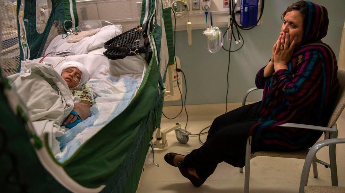 Malalai Rafi watches over her son Omar, 8, in the recovery room at UC Davis Children’s Hospital after his cranioplasty surgery on Aug. 13, 2015 in Sacramento. Surgeons tried to put a piece of his skull back into place, which had been removed in a previous procedure due to brain swelling. The surgery was not successful and he had to wear a protective helmet until they could perform surgery again in May.
