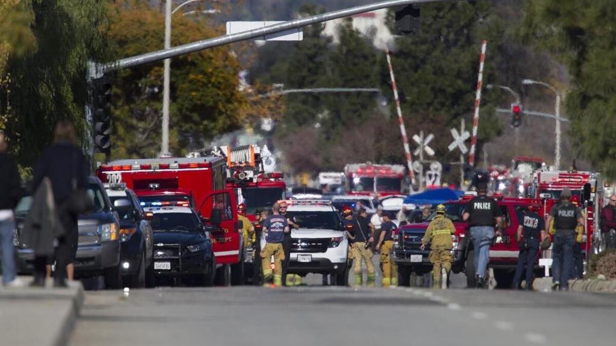 Police and fire personnel secure the scene of a mass shooting at the Inland Regional Center in San Bernardino, Calif., on Wednesday, Dec. 2, 2015.