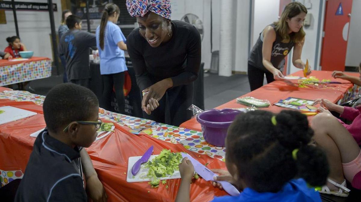 Cooking instructor Tigidankay Fadika,center, instructs Kosi Iwobi 11, left, and his sister Chinecherem Iwobi 9 during a healthy cooking lesson in Roseville on Friday, June 9, 2017. A new Roseville initiative is boosting healthy living in three low-income neighborhoods