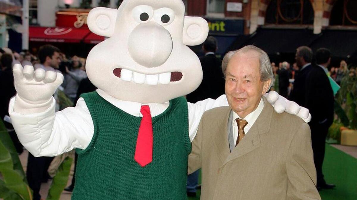 this Sunday, Oct. 2, 2005 file photo, British actor Peter Sallis, who voices the part of Wallace poses with a person dressed as the character 'Wallace' on arrival at the Leicester Square Odeon, London for the premiere of Wallace & Grommit: The Curse of the Were-Rabbit. Sallis, who played irrepressible, cheese-loving inventor Wallace in the "Wallace and Gromit" cartoons, has died. He was 96. Sallis' agents, Jonathan Altaras Associates, say he died Friday, June 2, 2017 in London.