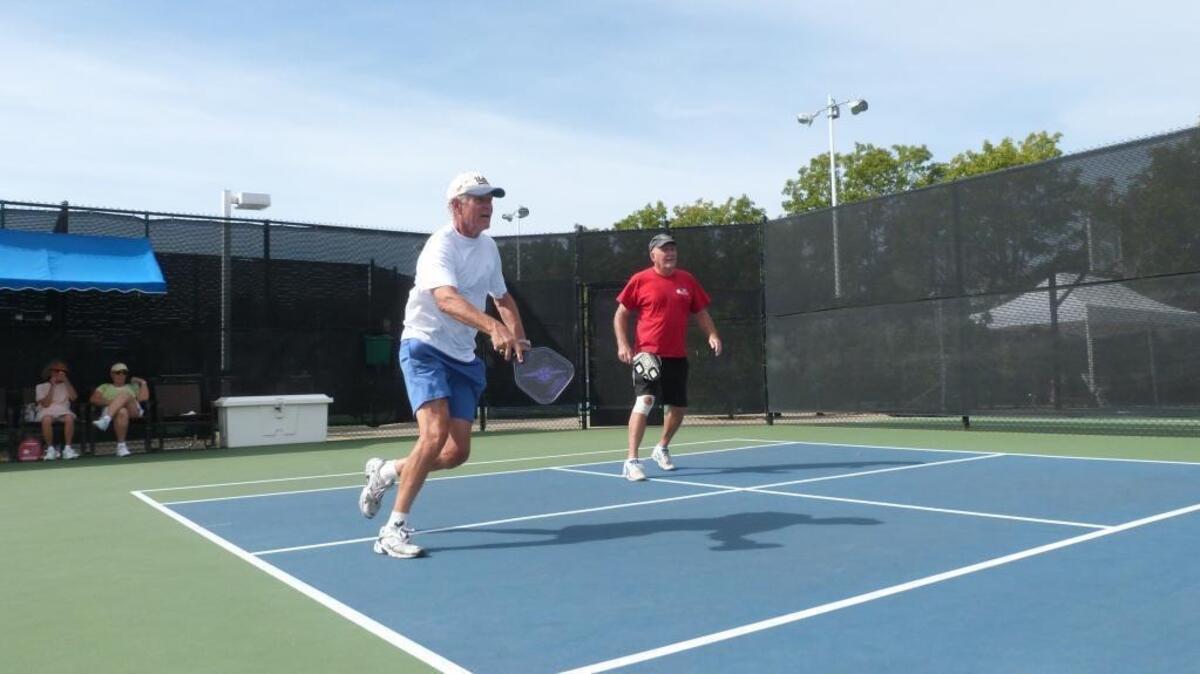 
Gene Cochran, 75, and Randy Julian, 67, play a game of pickup pickleball at Sun City retirement community in Roseville. The friends play about four times weekly.
