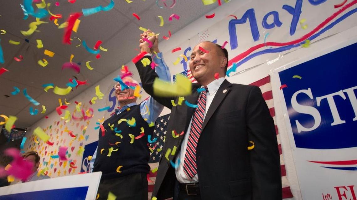 Carmine Forcina, left, raises the hand of Elk Grove mayor-elect Steve Ly at an election returns party.