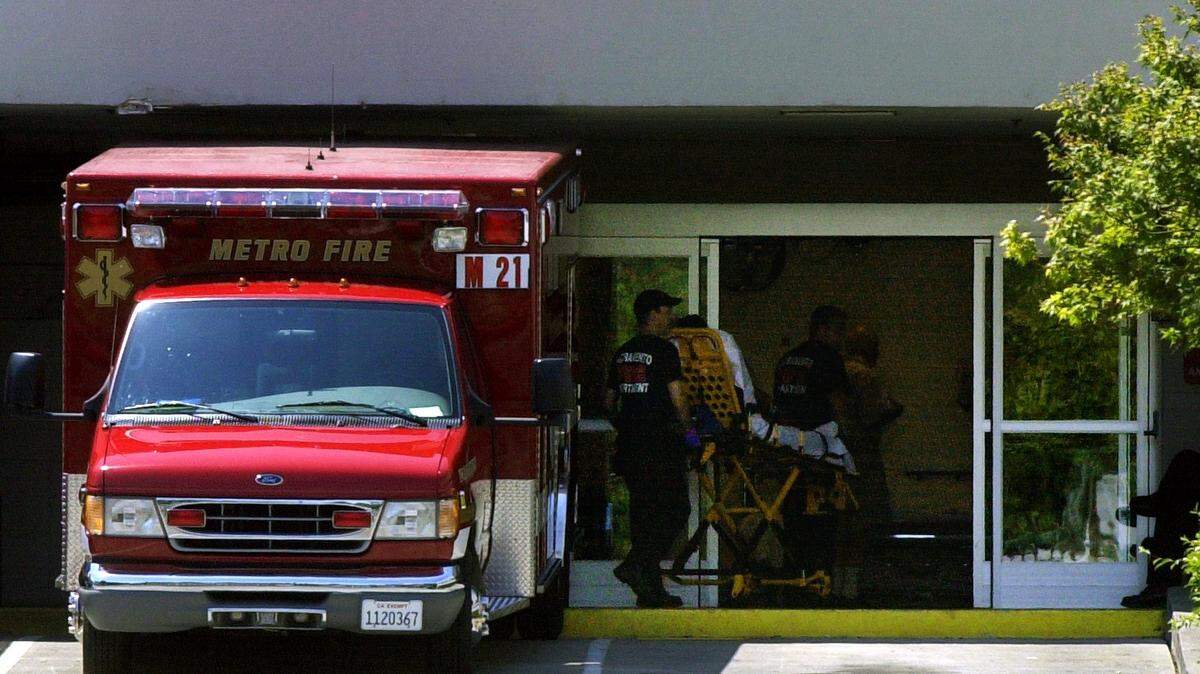 A patient is transported from an ambulance to the entrance of the emergency room at UC Davis Medical Center in Sacramento. New figures show that Sacramento County residents make more trips to emergency rooms than residents of other parts of California.