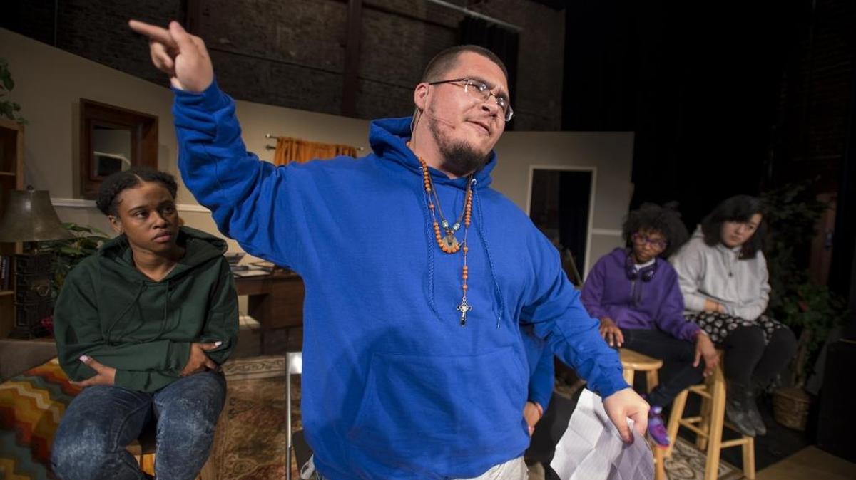 Alex Cuevas, center, performs a monologue during a dress rehearsal of the play “Trigger,” a story about youths who experience emotionally and physically violent trauma.