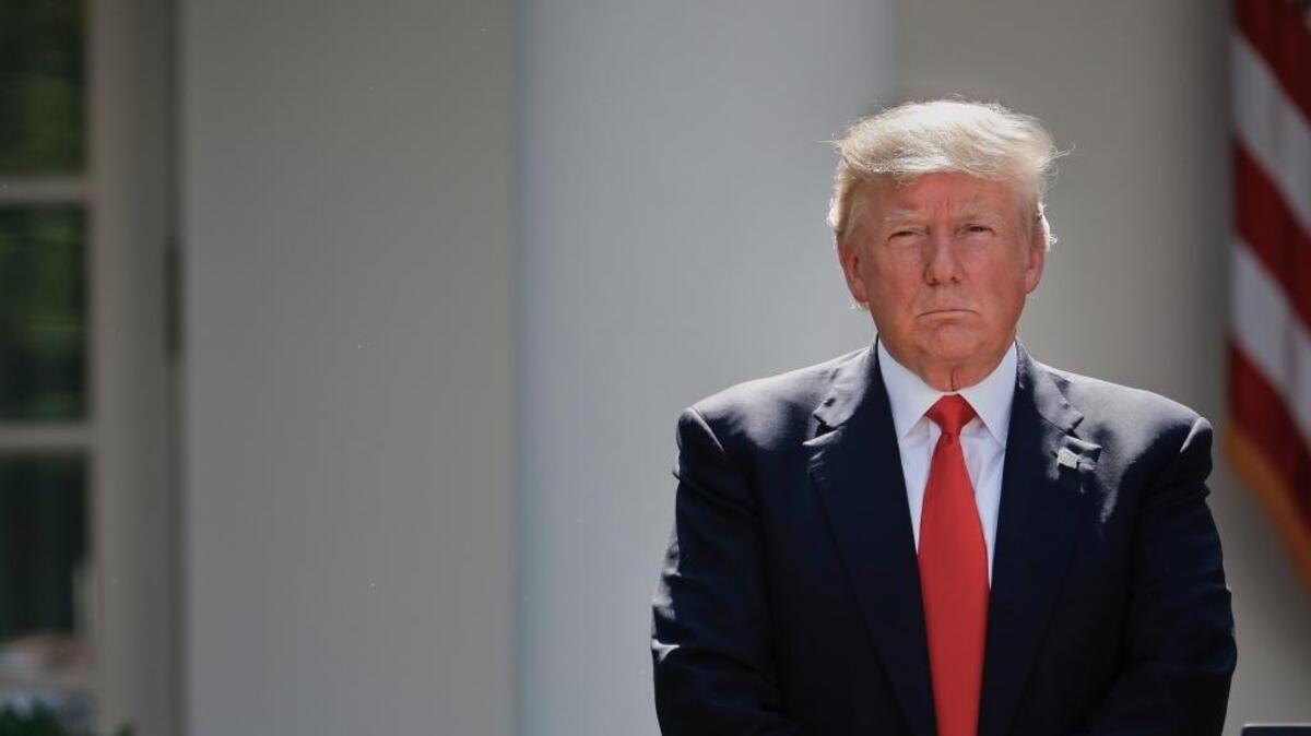 President Donald Trump stands next to the podium after speaking about the U.S. role in the Paris climate change accord, Thursday, June 1, 2017, in the Rose Garden of the White House in Washington.