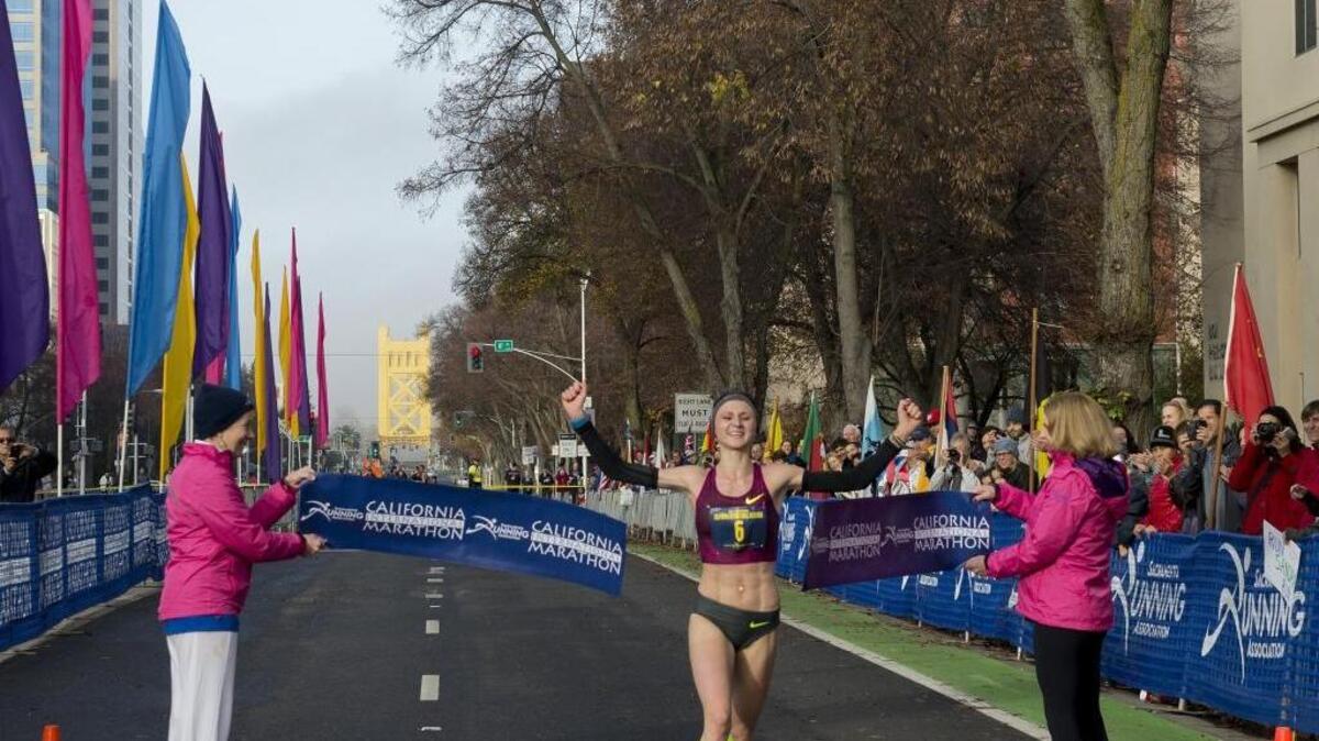 Volha Mazuronak of New York breaks a record as she wins the 32nd annual California International Marathon Sun., Dec. 7, 2014, that started in Folsom, Calif. and ended at the state Capitol. Security at the race is not being increased this year.