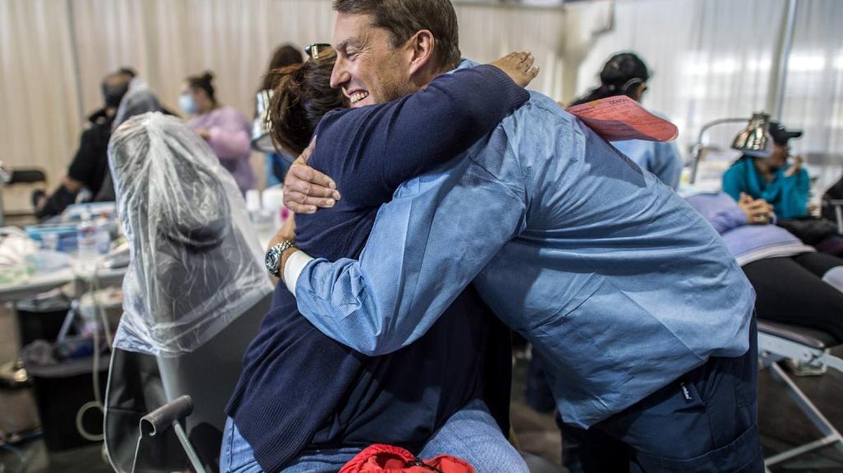 Dental hygienist Michael Laflamme, right, of San Francisco, is hugged by patient Joanna Ruiz of Elk Grove after he gave her a deep teeth cleaning at the California Careforce event in Sacramento, Calif., on Sun., Sept. 24, 2017. “He took care of me and put my fears at rest,” said Ruiz who was thankful for the free healthcare clinic.