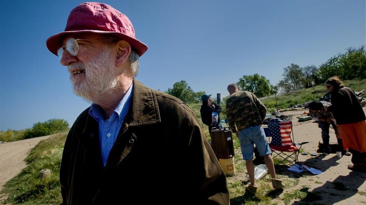 Loaves & Fishes founder Dan Delany joins with homeless residents and other supporters to prepare for a possible confrontation with police at a homeless “tent city” in Sacramento in 2009. Mr. Delany and his wife often found themselves protesting for a variety of causes.