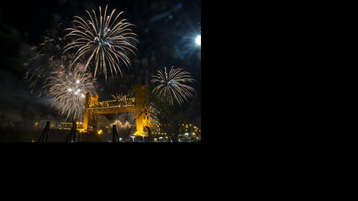 
Sacramento celebrates the new year with fireworks over the Tower Bridge linking West Sacramento and Sacramento on Dec. 31, 2013.
