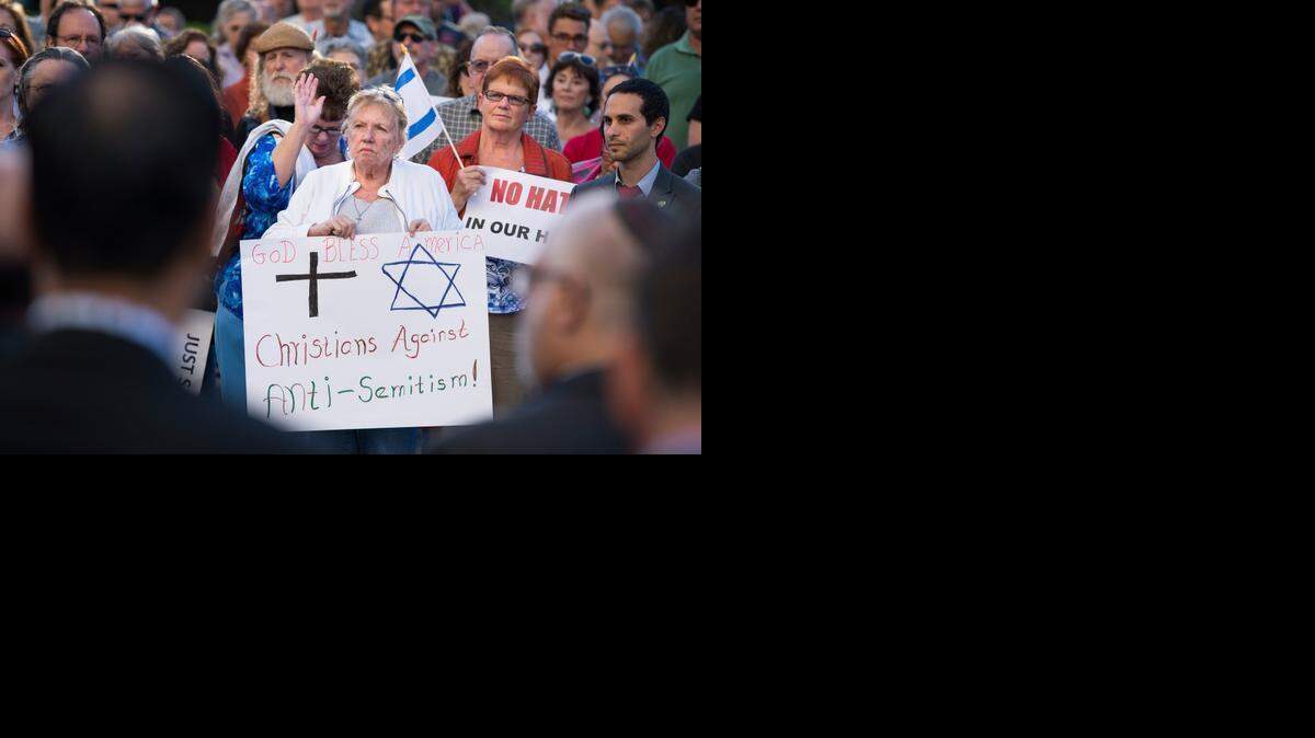 
Edie Murphy of Winters, center, holds a sign against anti-Semitism as Barbara Graffigna of Citrus Heights, left, and Carole Tatem, right, stand with her during the Jewish Federation of the Sacramento Region’s rally at the state Capitol on Monday in Sacramento. The group held the rally in response to recent events worldwide, including the painting of swastika on a Jewish fraternity at UC Davis and the controversy over a swastika display at a Sacramento home.
