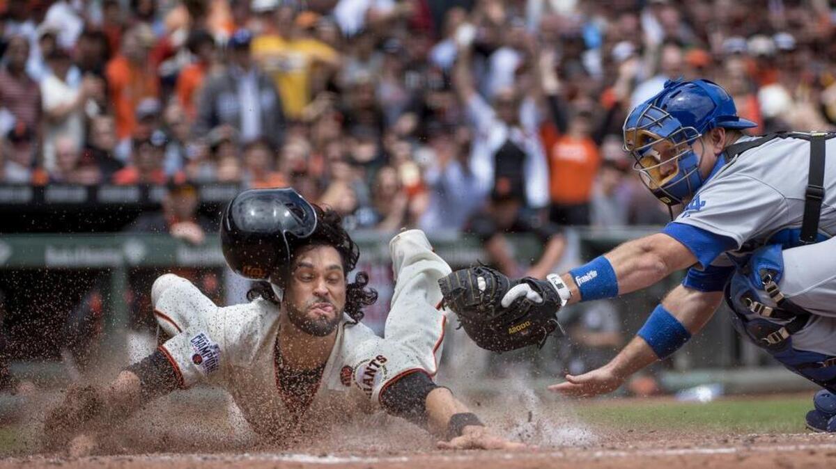 Sacramento Bee photographer José Luis Villegas was awarded first place in the Inland Press Association annual newspaper contest’s sports photo category for “Safe at Home,” this picture of San Francisco Giants player Ángel Pagán scoring against the Los Angeles Dodgers.