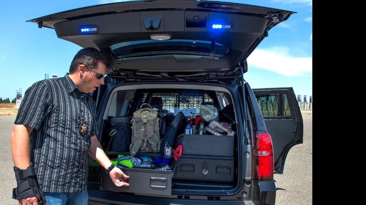 
Roseville police Officer Dan Wanamaker shows off drawers used to store equipment in the Chevy Tahoe patrol cruiser on Wednesday in Roseville. 
