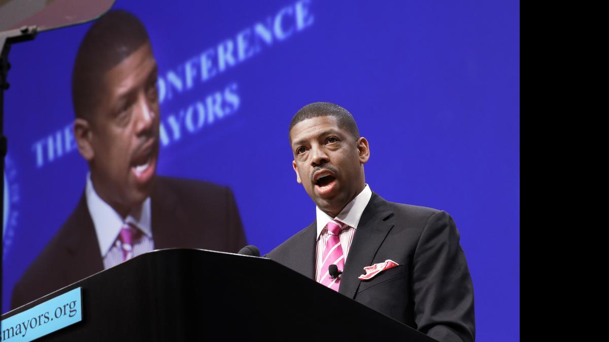 
Mayor Kevin Johnson, president of the U.S. Conference of Mayors, speaks before a panel discussion about sports and race relations during a conference meeting last summer in Dallas.
