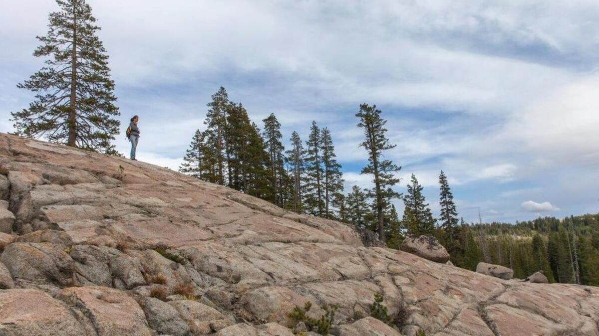 A hiker takes in the view from Castle Peak. The U.S. Forest Service bought the popular backcountry area’s trailhead March 25.