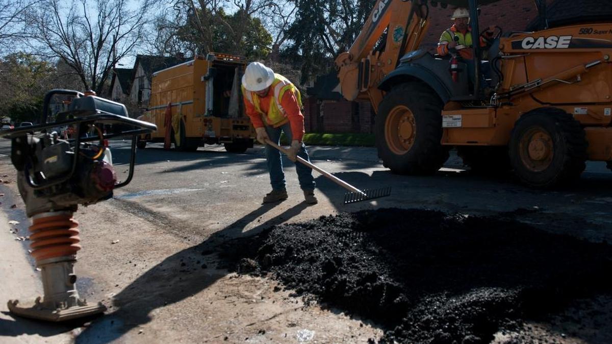 Utilities workers repair a road in East Sacramento where a water main burst in 2012. The City Council is to vote Tuesday night on water and rate increases. If approved, the city will also benefit from a tax on utility bills.