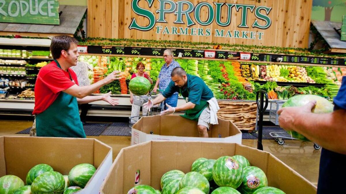 Richard Ross and Augustine Grine restocks watermelon at the produce department of Sprouts Farmers Market in Roseville, CA. June 15, 2011.