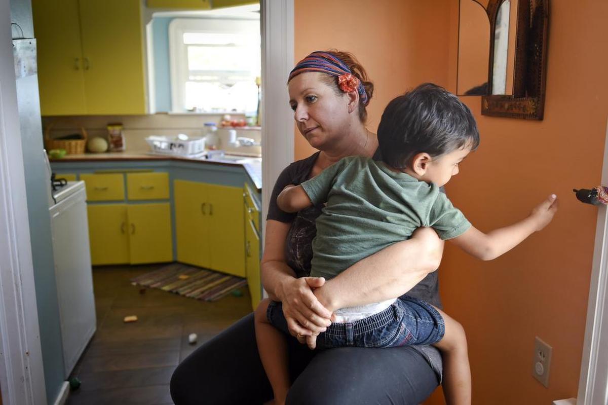 Kate Singh holds her son Sammy, 3, on Tuesday as she waits for news of her husband Baljit “Bali” Singh, who was detained by ICE during a regular check-in last week.