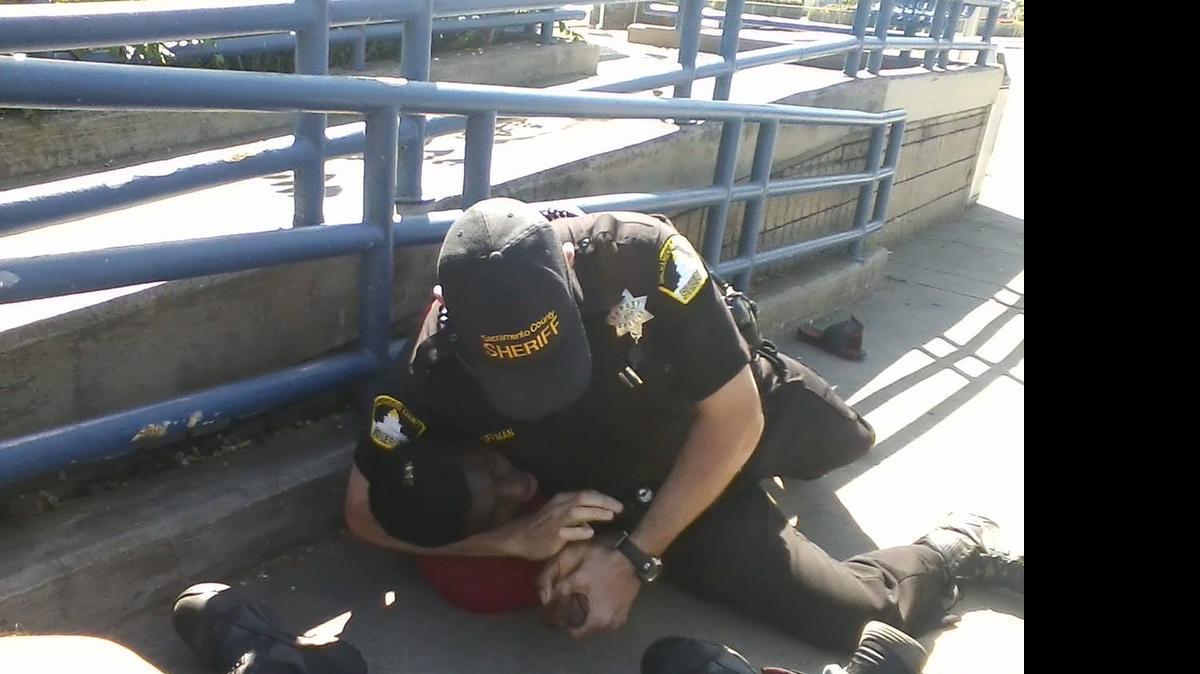 
Bystander and local activist Independence Taylor photographed two light-rail officers detaining two black teens after the boys were seen chasing each other with sticks on April 26 in Sacramento.

