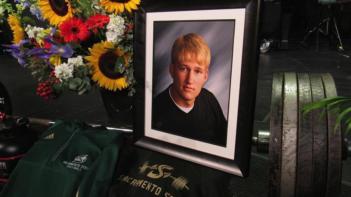 
Strength coach Jeff Law’s funeral was held last month in Iowa City. Among items on display were a weight bench, nutritional supplements and a Sac State football helmet signed by players.
