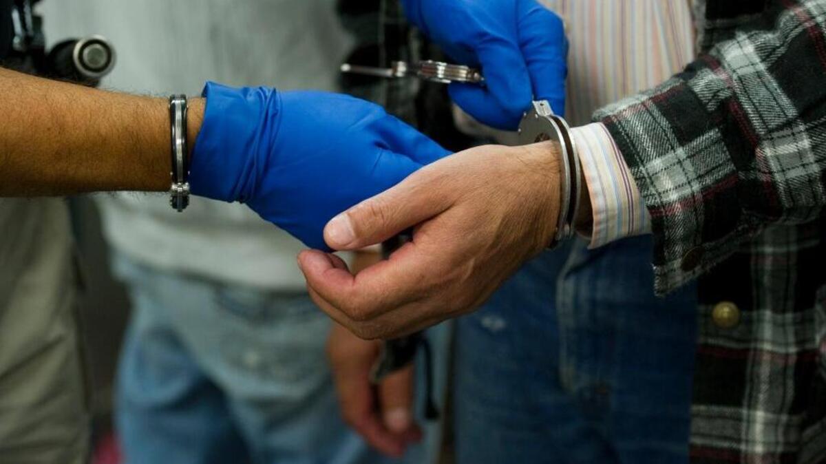 A detainee has his hands uncuffed after arriving to the Immigration Customs Enforcement processing office in downtown Sacramento on Wednesday, September 15, 2010.