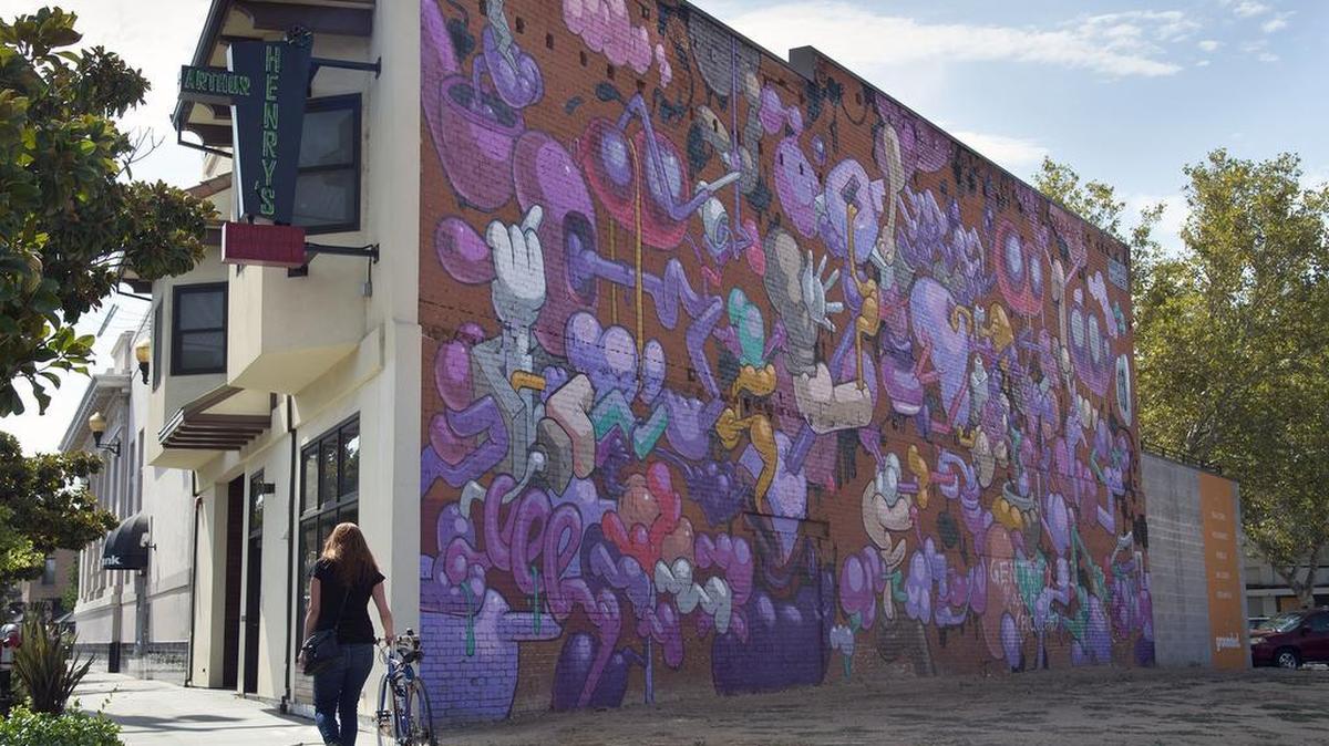 A mural painted on a building by artist Waylon Horner at Broadway and 34th Street during Open Walls 2017 has been defaced on Tuesday, September 12, 2017 in Sacramento, Calif.