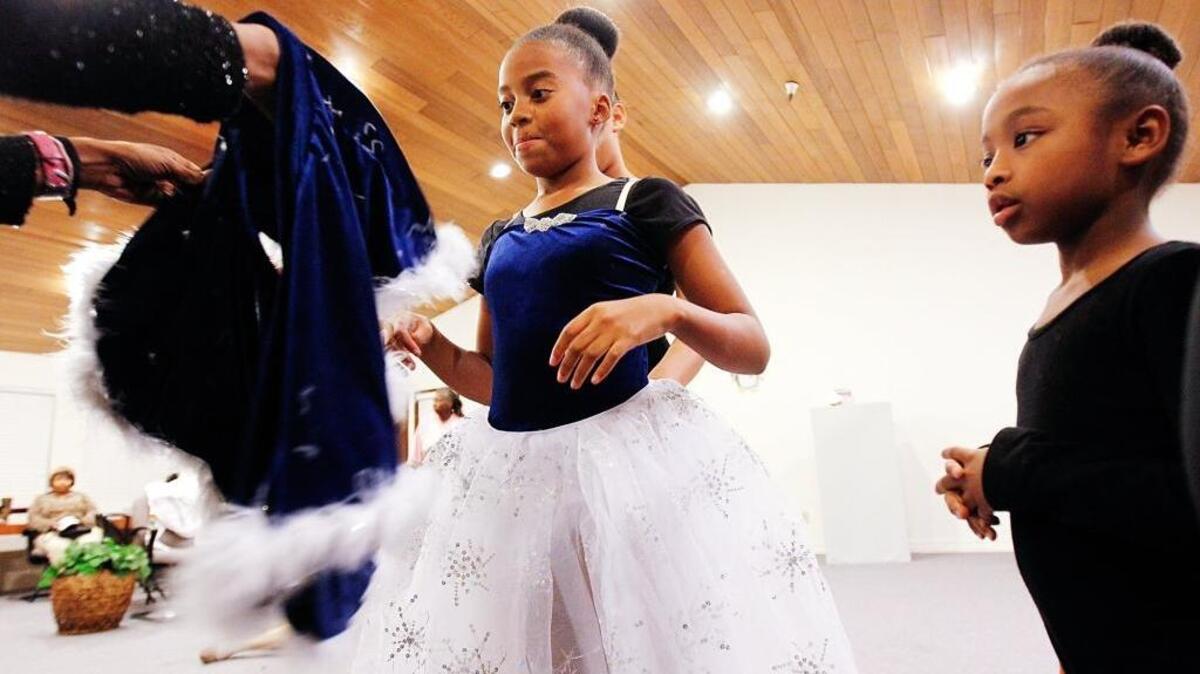 Ten-year-old Denver Russell gets help with her costume before a rehearsal for the “The Nutcracker” in 2013 at Fruitridge Collaborative Theatre in Sacramento.