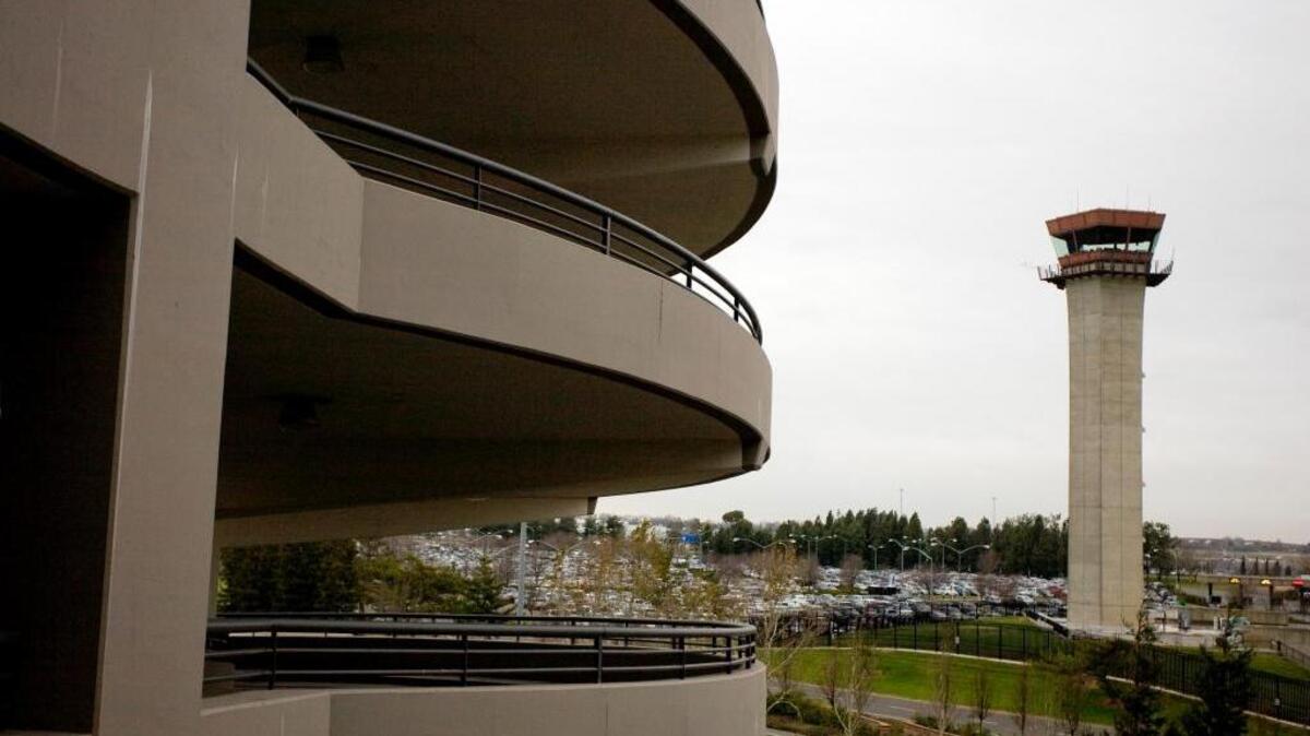 
The Terminal A parking structure, left, is contrasted against the 150-foot tall control tower built in 1967. A new hotel in the planning stages for Terminal B at Sacramento International Airport may obscure the view of planes for air traffic controllers. Airport officials want to build a new tower but the FAA said no. 
