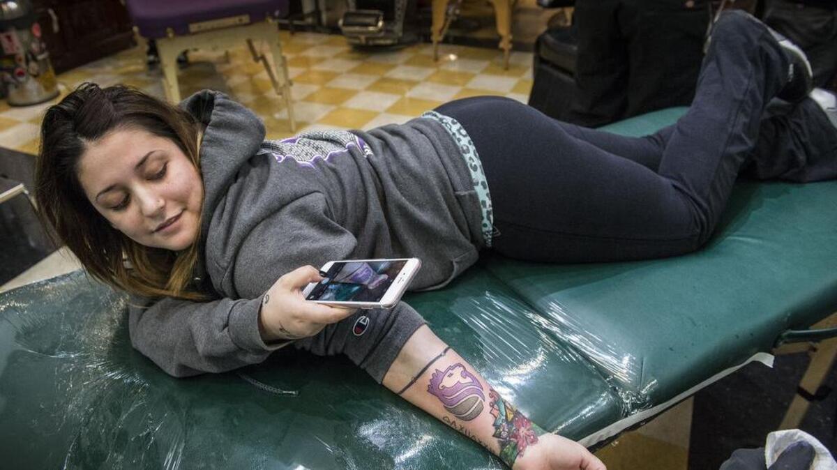 “We went to Kings games all my life and it’s something I want to have on me,” said Syrena Thoreson, 21, of Elk Grove who also said that her husband thought it was stupid to get a Kings tattoo. A happy Thoreson takes a picture of her completed tattoo at Royal Peacock on Wednesday, April 27, 2016. The Kings paid for the first 41 fans in line, and the shop offered discounts to others seeking Kings ink on Wednesday.