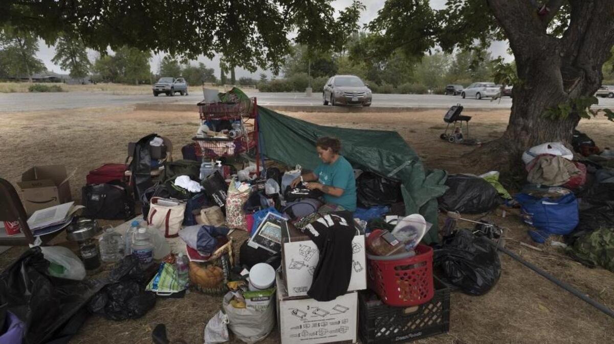 Jamie Brody, 37, who has been homeless for a year and a half, packs her belongings at a popular transient encampment in Auburn on Aug. 6. Residents of the encampment were evacuating following a Placer County ordinance banning unauthorized camping on county land.
