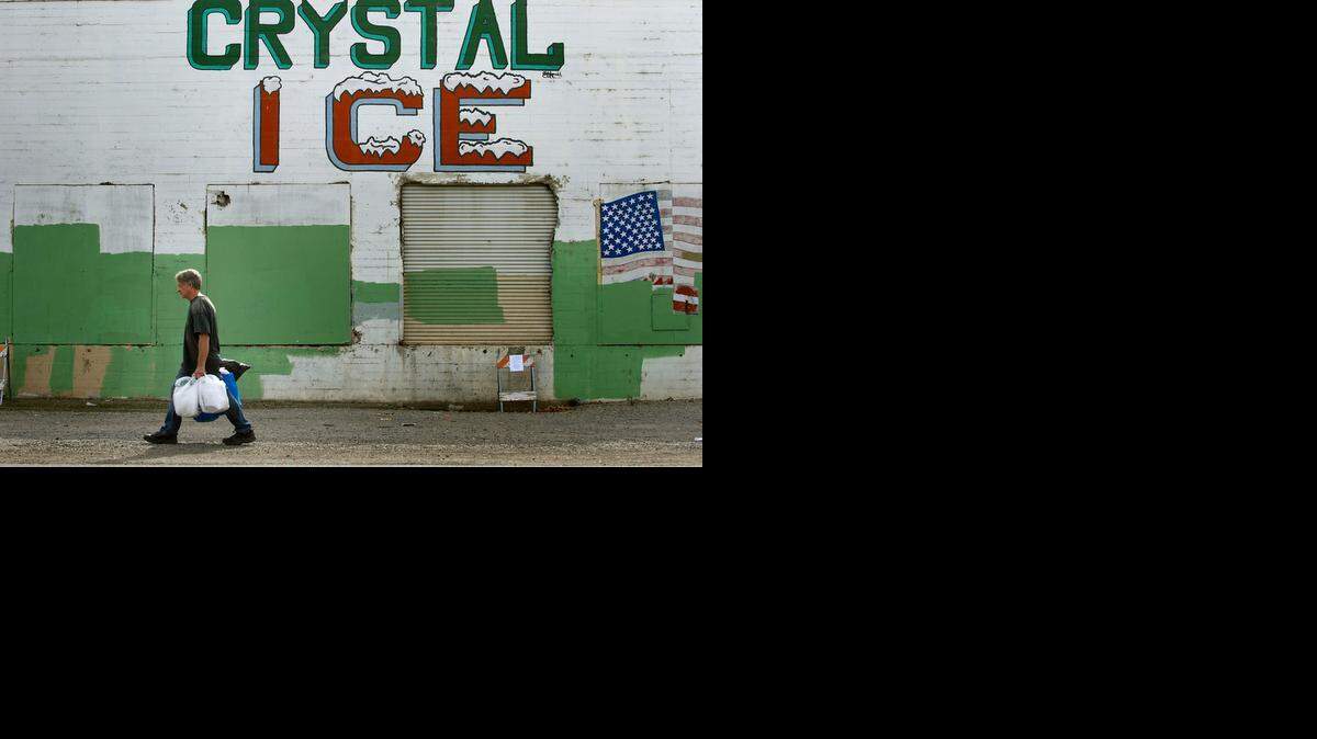 
A pedestrian walks past the old Crystal Ice and Cold Storage plant on R Street in Sacramento on Thursday. Developer Michael Heller is about to submit plans to the city to rehabilitate the dilapidated structures between 16th and 18th streets for use as retail shops, restaurants and residential units.
