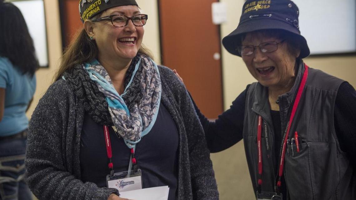 Women veterans Norma Christensen, left, and Kiyo Sato laugh together Sunday while attending the 2017 Women Veterans Alliance Unconference at McClellan Park. Sato, 94, was put in a Japanese internment camp as a teenager. She then enlisted in the Air Force as a nurse and served in the Korean War.