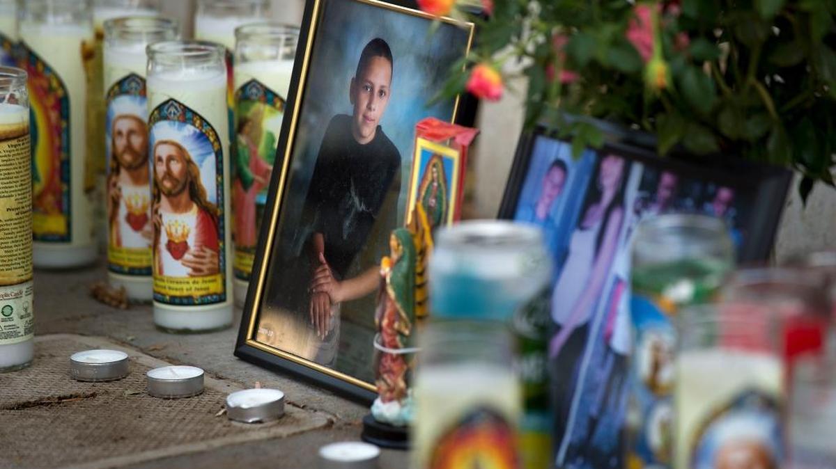 
Family, friends and neighbors create an impromptu memorial to Isaiah Diaz, 16, who was shot and killed earlier in the day while visiting his grandmother in south Sacramento on Saturday, Oct. 3, 2015.
