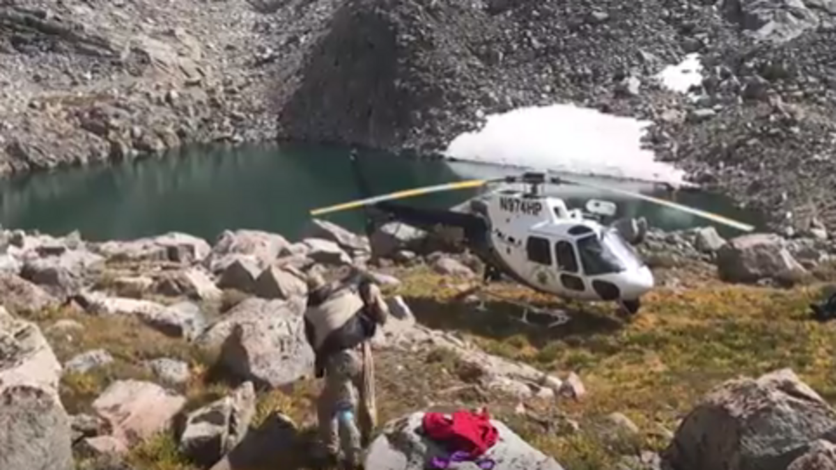CHP flight officer/paramedic Brandon Hallam helps Owen Mould of Marin to a helicopter after the injured Mould was located near Mount Lamarck in Inyo County on Sept. 6, 2017.
