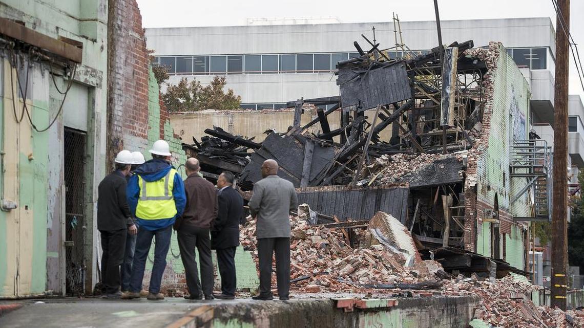 Contractors inspect the fire damage at the Ice Blocks Project.