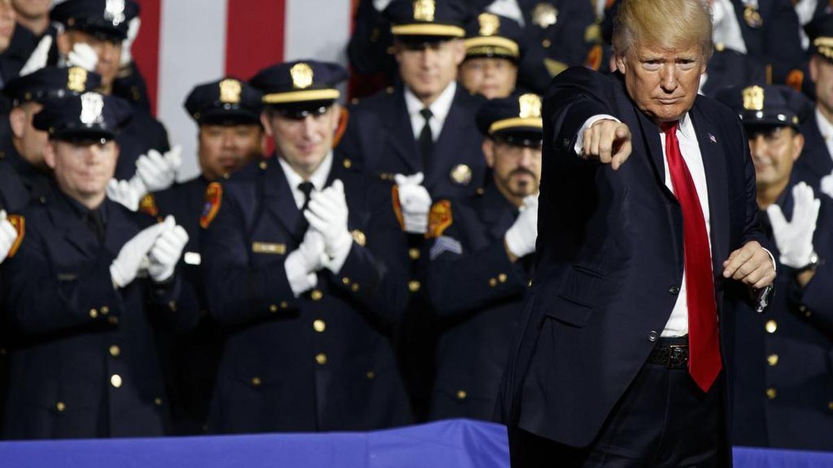 President Donald Trump points to the crowd after speaking to law enforcement officials on the street gang MS-13, Friday, July 28, 2017, in Brentwood, N.Y.