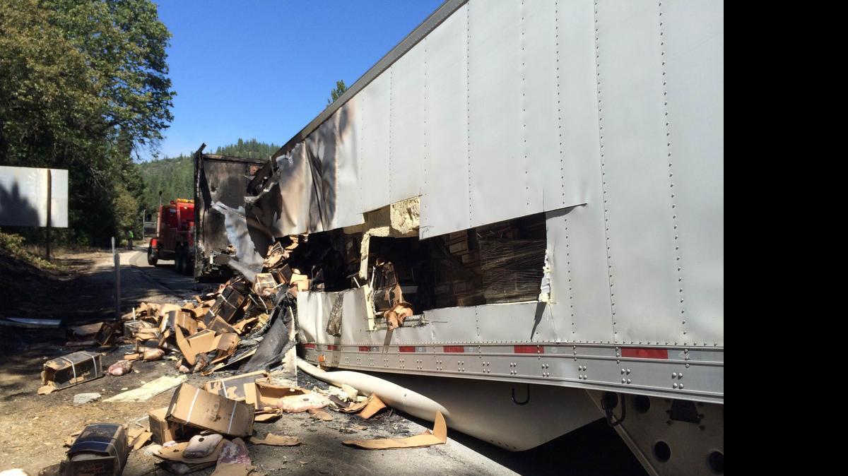 
Debris is strewn near the trailer of a big rig damaged by fire Sunday afternoon on westbound Interstate 80. The fire caused closure of the interstate and resulted in significant traffic delays.
