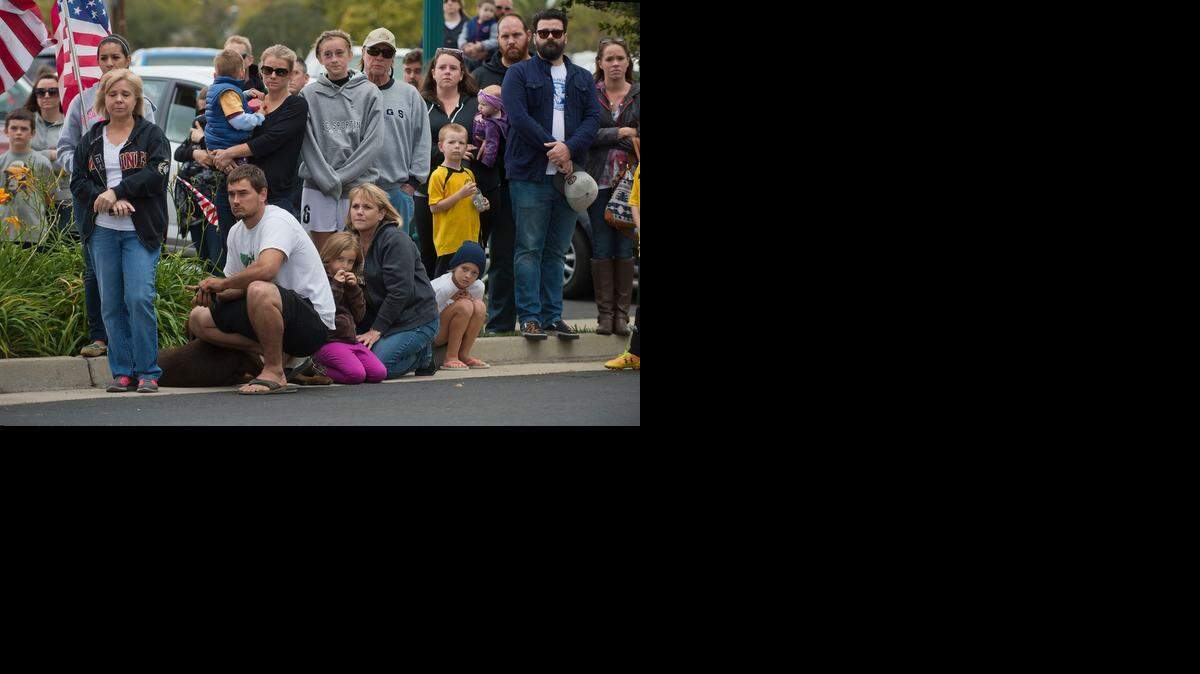 
A crowd watches as the body of Placer County Detective Michael Davis Jr. is escorted into the Chapel of the Valley on Vernon Street in Roseville on Saturday. Davis was killed in the line of duty Friday.
