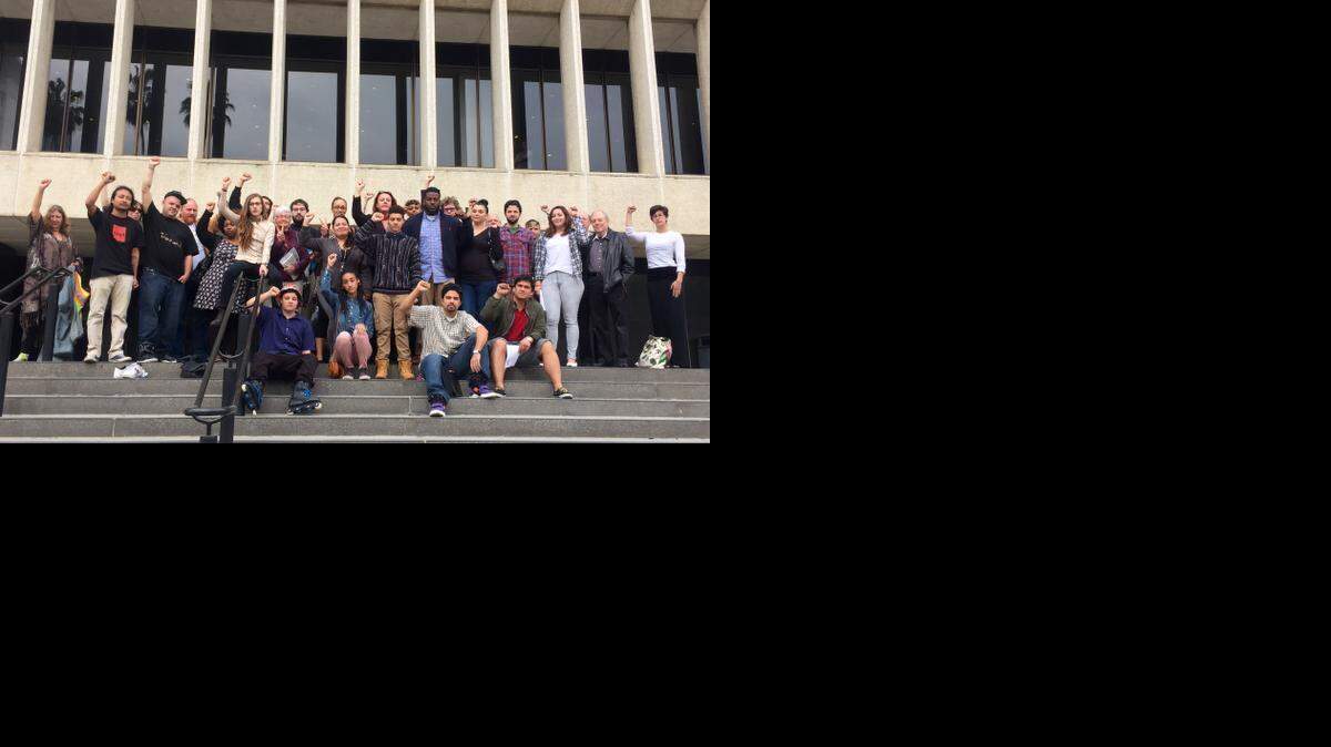 
Maile Hampton, 20, in the pale pink pants, poses on the steps of Sacramento Superior Court on March 16 after appearing on charges of lynching and resisting arrest. She is surrounded by people who came to support her at the hearing. 
