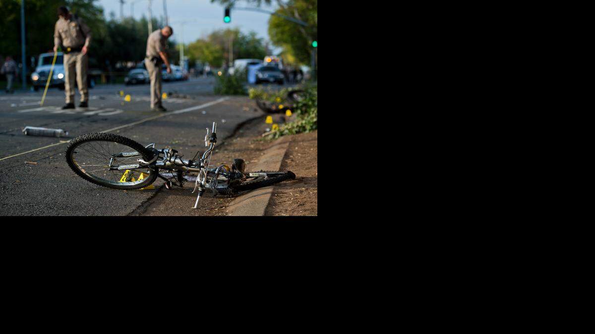 
CHP officers investigate where an SUV struck a bicycle in a crash that killed three people Thursday on Howe Avenue north of El Camino Avenue in the Arden Arcade area.

