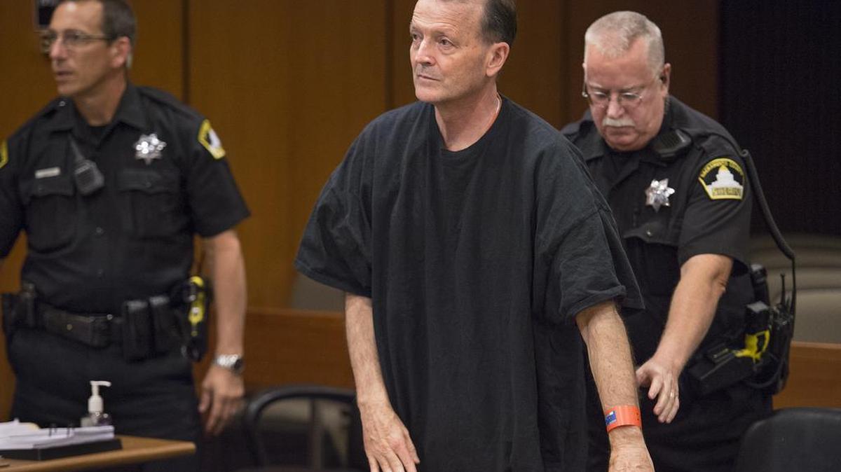 
A bailiff reaches to handcuff former Cal Fire chief Orville Fleming after his sentencing in Sacramento Superior Court on Friday. Fleming received a 16-years-to-life sentence for killing his girlfriend, Sarah Douglas at their Elk Grove-area home in May 2014.
