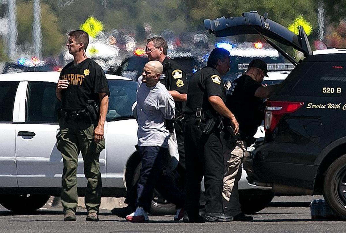 A suspect believed to be involved in the shooting of law enforcement officers is taken from the scene by Sacramento County Sheriff's Deputies, Wednesday, Aug. 30, 2017, in Sacramento, Calif.