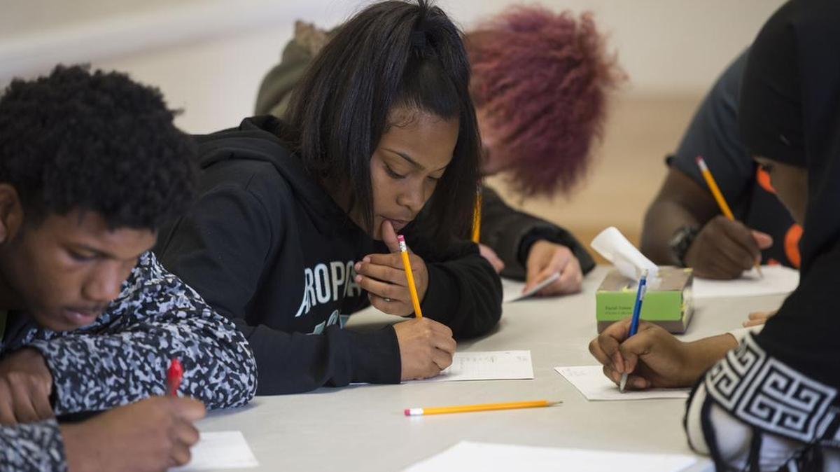 Tank Nash, 17, left, and other Grant High school students write during a slam poetry workshop put on by the UC Davis program, Sacramento Area Youth Speaks, Monday, March 7, 2016. The program was awarded a grant through the Mayor’s Gang Prevention and Intervention Task Force. Police said such programs have help reduce the crime rate in Sacramento.