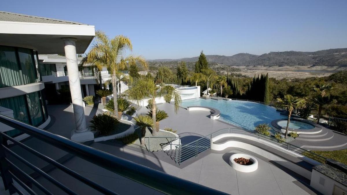The swimming pool over looks Folsom Lake at comedian Eddie Murphy’s former home in Granite Bay, Calif. Prosecutors said that after scamming $10 million from Murphy’s ex-wife, Troy Stratos convinced Nicole Murphy to refinance the mansion to generate another $3 million.