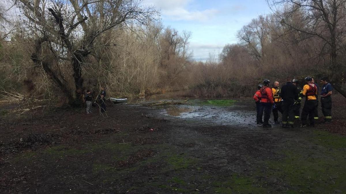 Sacramento Fire Department personnel gather at the pond at Reichmuth Park, where a man’s body was found Wednesday morning.