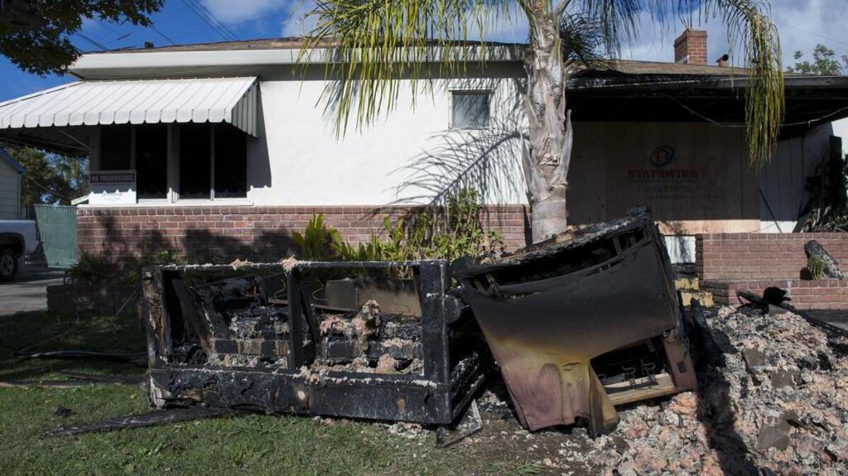 Burned furniture sits on the front lawn of the Happy Homes board and care home in south Sacramento after an early morning fire killed one resident authorities say, Sunday, November 15, 2015.