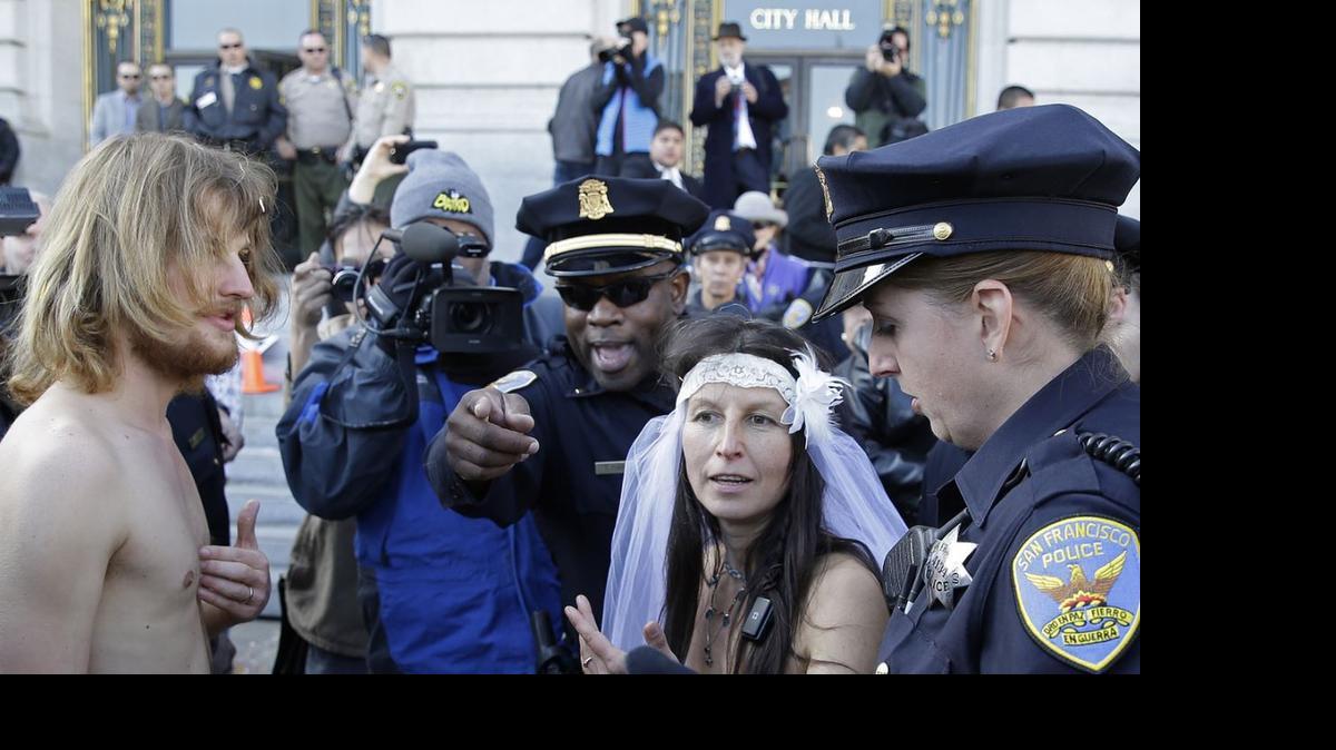 
San Francisco police lead Gypsy Taub, right, and Jaymz Smith, left, to a van after their nude wedding outside City Hall in December, 2013. In Sacramento, a proposed amended ordinance would make it illegal to be nude on city streets, sidewalks or on private property visible from a public right-of-way.
